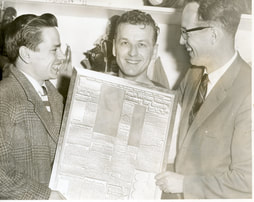 Gordon Fashoway presented with newspaper article about his records 400th goal in the Western Hockey League (WHL)